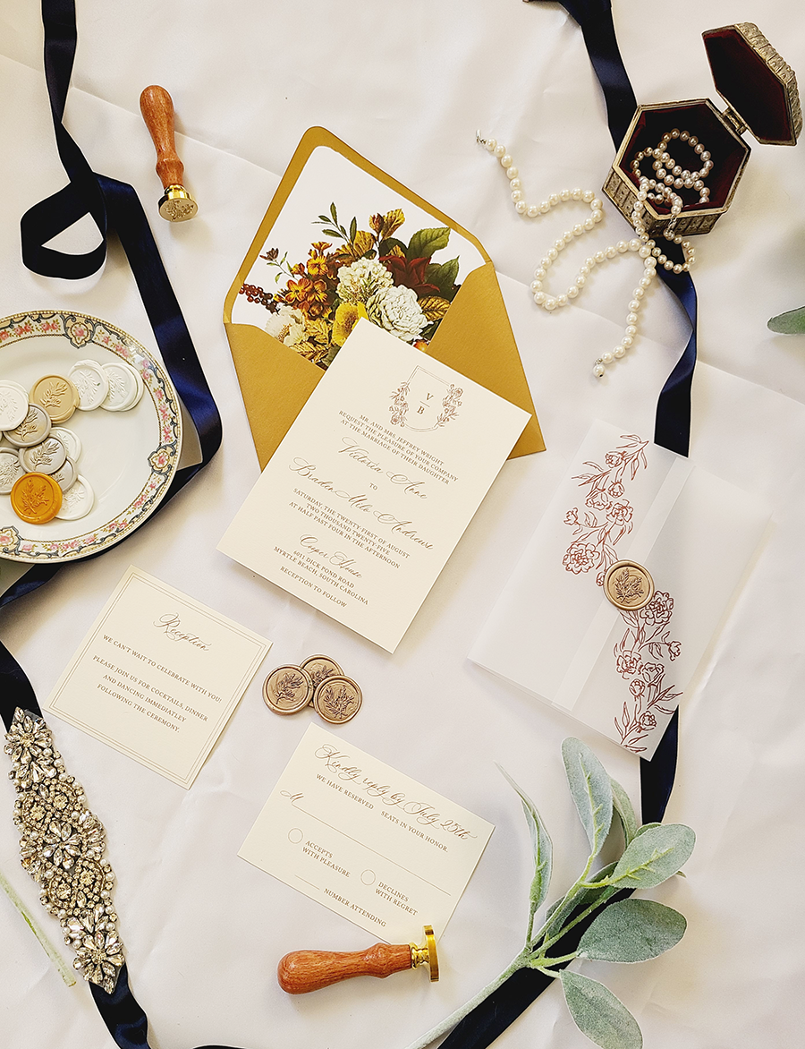 the filippa wedding invitation suite with classic monogram crest and hand drawn flowers in burgundy and gold