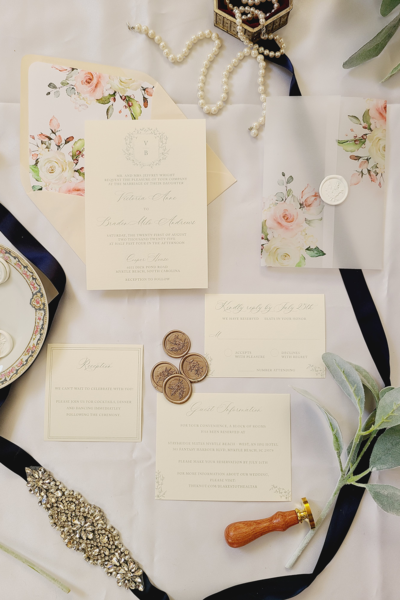The Pheobe Wedding Invitation Suite with classic monogram crest and pastel flowers
