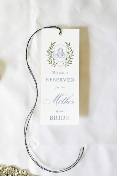 sibyl dusty blue monogram crest reserved seating tag